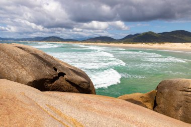 Rocks and waves at Joaquina beach, Florianopolis, Santa Catarina, Brazil