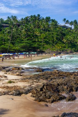 Rocks, waves, sand and vegetation at Praia do Resende beach, Itacare, Bahia, Brazil