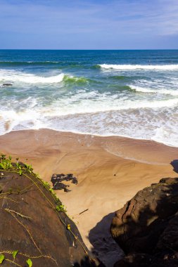 Rocks, waves, sand and vegetation at Praia do Resende beach, Itacare, Bahia, Brazil