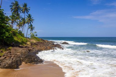 Rocks, waves, sand and vegetation at Praia do Resende beach, Itacare, Bahia, Brazil
