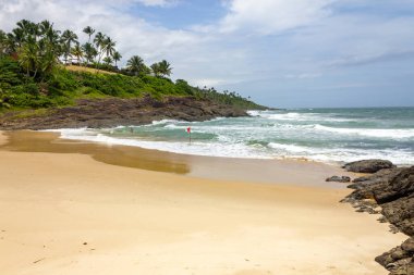 Vegetation, sand and waves at Praia da Costa beach, Itacare, Bahia, Brazil