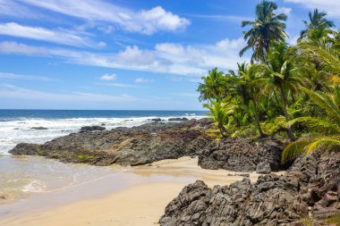 Sand, waves and rocks at Havaizinho beach, Itacare, Bahia, Brazil