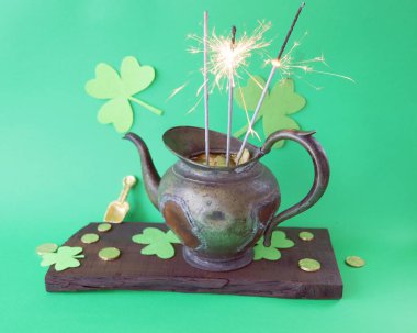 Patrick's Day, vintage pot with gold coins and burning sparklers, on a wooden background with shamrocks, holiday, party, interior decoration