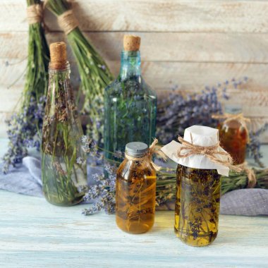 Lavanta çiçekleri, teneke şişeler ve lavanta yağı kavanozları, ahşap arka planda, doğal malzemeler, alternatif ilaçlar.