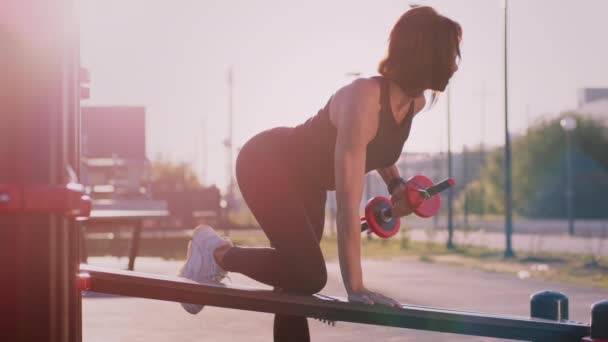 Motivated Woman Sportswear Lifts Dumbbell Pump Forearm Muscles Putting Leg — стоковое видео