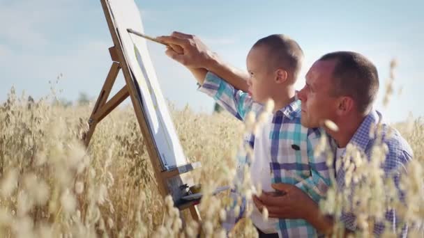 Caring Father Helps Little Son Syndrome Paint Canvas Easel Standing — Stockvideo