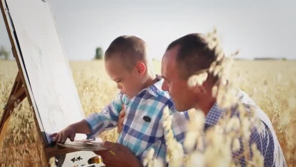Preschooler Boy Syndrome Paints Easel Canvas Fingers Control Father Man — Stockvideo
