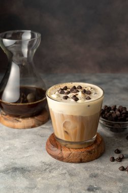 Coffee and vanilla ice crem with chocolate , coffee beans in glass cup, copy space. Lisestyle iced coffee drink