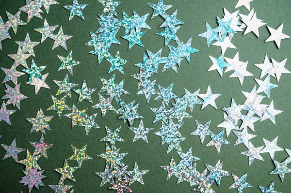 Christmas green background with shining stars. Flat lay mockup, top view copy space.
