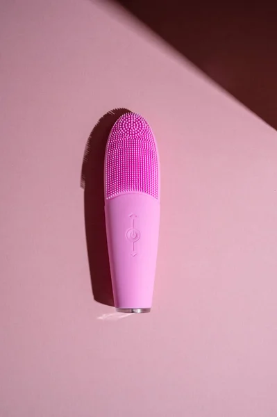 stock image Pink silicone brush, face washing device. Beauty device. Deep cleanser and massager on pink background.