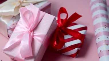 Pink gift box with satin bows, birthday, Mothers Day or Valentines Day background.