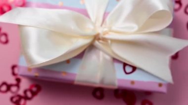 Valentines day, pink gift box and red heart confetti, selective focus, birthday, Mothers Day.
