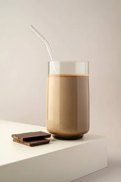 Protein shake, drink with protein rice powder with glass straw. Vertical image