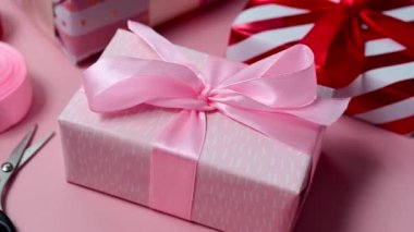 Pink gift box with satin bows, birthday, Mothers Day or Valentines Day background.