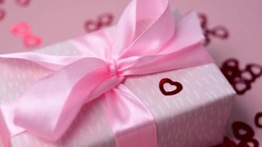 Valentines day, pink gift box and red heart confetti, selective focus, birthday, Mothers Day.