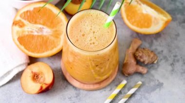 Fresh orange smoothie, peach, ginger and orange blended healthy drink