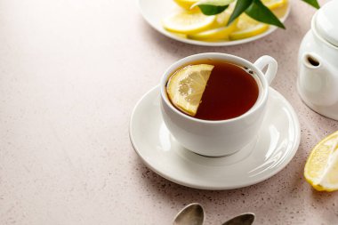 White cup of black tea and lemon slice. Drinking tea, copy space
