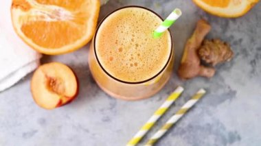 Fresh orange smoothie, peach, ginger and orange blended healthy drink