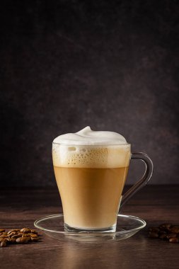 Cups of coffee drink, latte or mocha with milk foam. Glass mug, dark wooden background. clipart