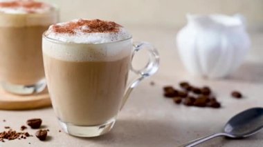 Two glass cups with coffee drink, latte with milk foam