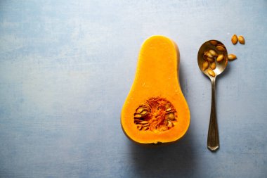 Kabak kabağı ve tohumlar mavi arka planda. Boşluğu kopyala.