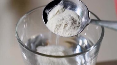 Bir bardak suya kolajen tozu ekliyorum. Sağlıklı olmak için gıda takviyesi.