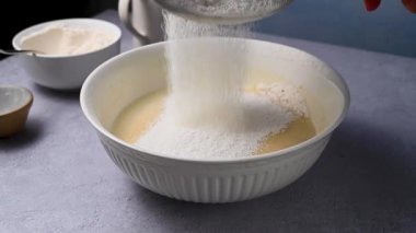 Womans hand sifting flour through sieve. Baking, cooking, pastry concept. Top view