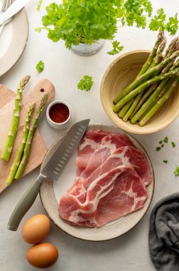 Bacon with fresh asparagus and eggs. Ingredients for cooking breakfast