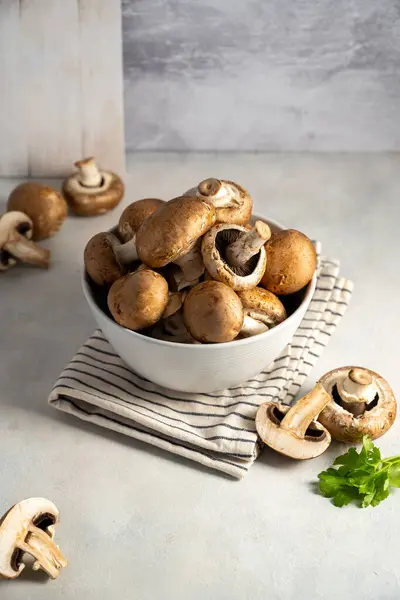 stock image Raw champignon in a bowl, on bright background, button mushrooms. Vegan protein