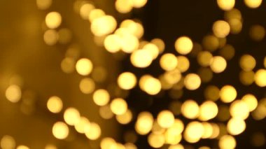 Noel soyut altın kahverengi bulanık bulanık bokeh ışık arkaplan, 4K video arkaplan.