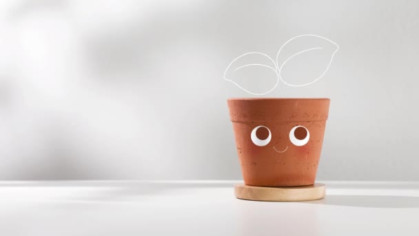 小さな鉢植えの想像力 テラコッタの鍋の可愛らしさと左側の空のスペース — ストック動画