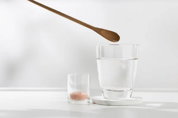 ピンクのヒマラヤミネラル塩を健康のための飲料水に混ぜる — ストック写真