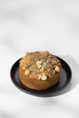 Beyaz ahşap masada siyah tabakta Tayland muzlu keki.