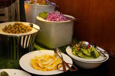 A vibrant display of fresh salads and fruits at a luxurious 5-star hotel buffet in Muscat, Oman, set for Iftar. clipart