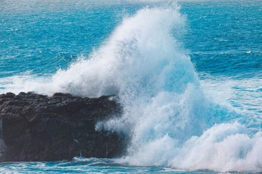 Big wave beating the rock . Cliff breaking the ocean wave clipart