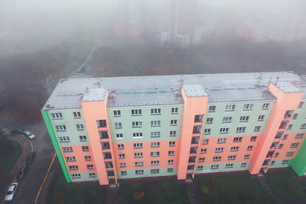 Multi-storey city building view from above . Urban residential house in the fog