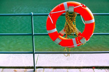 Lifebuoy with ropes . Lifebuoy ring at waterfront