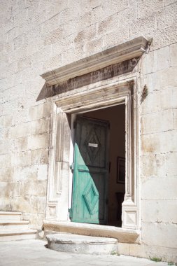 Opened door to the church . Entrance Entrance . White wall and doorway 