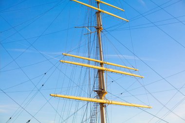 Masts with lowered sails . Nautical masts against sky 