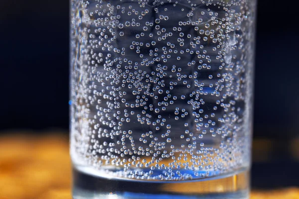 Sparkling water in transparent glass cup . Drinking soda water