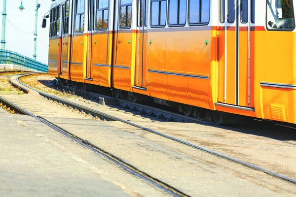 Yellow tram and rails . Urban passengers transportation
