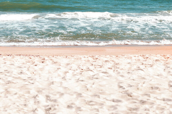 White sand beach . Sea waves view from the coast 