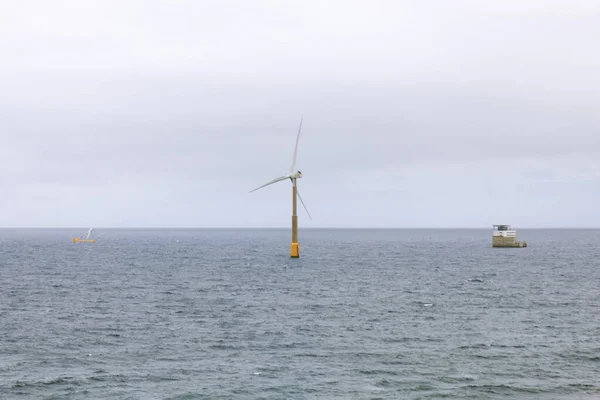 Single wind turbine in the ocean . Offshore Windmill