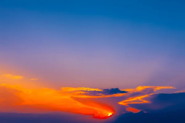 Sunset sky background. Colorful twilight sky with clouds and sun