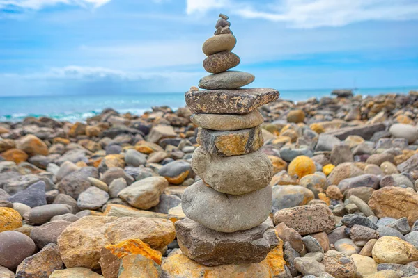 Balanced stones on the coast . Pebble beach with stacked up stones
