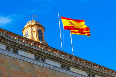  Spanish flag situated on the building rooftop clipart