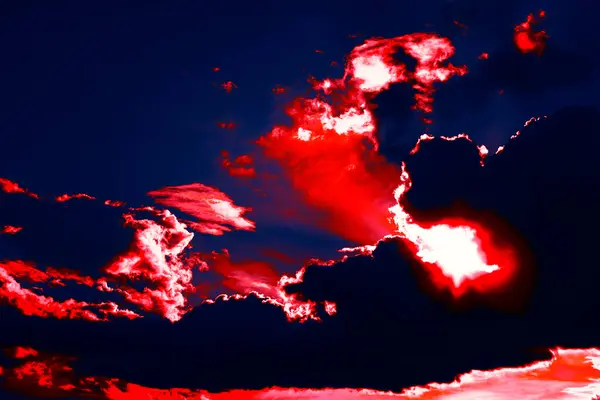 stock image Surreal sky with red clouds. Vibrant red sky filled with fluffy clouds, creating a dramatic and striking atmosphere at dusk. Surreal sky with red clouds