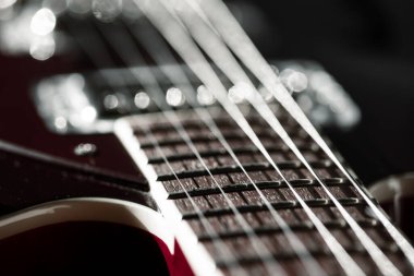 Boynunu vurgulayan bir gitarın detaylı görüntüsü. Elektro gitarın telleri.