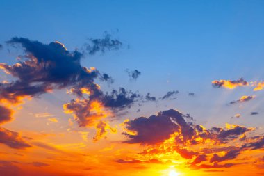 Vibrant sunset with clouds. Sun rays break through the evening clouds clipart