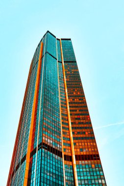 Montparnasse Tower in Paris. Modern skyscraper with a glass facade. The building has a sleek, angular design with multiple vertical sections, each covered in reflective glass panels clipart